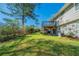 Large backyard with a deck, mature trees, and green grass creating an inviting outdoor space at 4205 Whittier Ct, Decatur, GA 30034