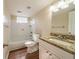 Well-lit bathroom with granite countertop, white cabinets, and tiled shower-tub combo at 4205 Whittier Ct, Decatur, GA 30034