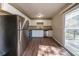 Modern kitchen boasts stainless steel appliances, white cabinets, wood floors, and sliding door access to outdoor deck at 4205 Whittier Ct, Decatur, GA 30034