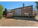 Brick house with a lush backyard featuring mature trees, and manicured landscaping, for relaxation at 4540 Hastings Dr, Cumming, GA 30041