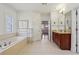 Spacious bathroom with a soaking tub and vanity with storage at 4540 Hastings Dr, Cumming, GA 30041
