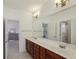 Primary bathroom with wood cabinets, double sinks and large mirror at 4540 Hastings Dr, Cumming, GA 30041