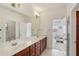 Primary bathroom with wood cabinets, double sinks and large mirror at 4540 Hastings Dr, Cumming, GA 30041