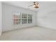 Bedroom with large windows to let in natural light and neutral carpeting, plus a ceiling fan at 4540 Hastings Dr, Cumming, GA 30041
