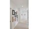 Long hallway featuring neutral carpet, light walls and artwork on display at 4540 Hastings Dr, Cumming, GA 30041