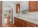 Kitchen with granite countertops, wood cabinets and stainless steel appliances next to an arched entryway at 4540 Hastings Dr, Cumming, GA 30041