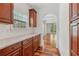Kitchen with granite countertops and wood cabinets and an arched entry into an adjoining room at 4540 Hastings Dr, Cumming, GA 30041