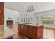 An open-concept kitchen with a granite island, a fireplace, and large windows with a view to the backyard at 4540 Hastings Dr, Cumming, GA 30041