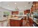 Bright kitchen with stainless steel appliances, granite countertops, and a center island with cooktop at 4540 Hastings Dr, Cumming, GA 30041