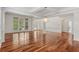 Open living room with hardwood floors, coffered ceilings, and large windows at 4540 Hastings Dr, Cumming, GA 30041