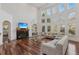 Spacious living room features hardwood floors, a fireplace, and a wall of windows for natural light at 4540 Hastings Dr, Cumming, GA 30041