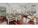 Bright living room showcasing large windows, hardwood floors, and stylish display case at 4540 Hastings Dr, Cumming, GA 30041