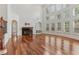Bright living room with a fireplace, built-ins, and a wall of windows at 4540 Hastings Dr, Cumming, GA 30041
