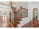 Elegant staircase featuring wood and wrought iron banisters at 4540 Hastings Dr, Cumming, GA 30041