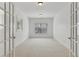 Study featuring neutral carpet, French doors and a large window with natural light at 4540 Hastings Dr, Cumming, GA 30041