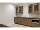 Modern bar area featuring wine storage, a sink, granite countertops, and stainless steel microwave at 46 Montclair Ne Dr, Atlanta, GA 30309