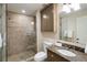 Modern bathroom featuring a glass-enclosed shower, marble vanity, and stylish fixtures at 46 Montclair Ne Dr, Atlanta, GA 30309