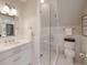 Well-lit bathroom featuring a tiled shower with glass door and a sink with white cabinets at 46 Montclair Ne Dr, Atlanta, GA 30309