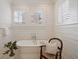 Elegant bathroom with a standalone tub, plantation shutters, and shiplap walls at 46 Montclair Ne Dr, Atlanta, GA 30309