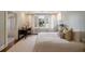 Bright bedroom featuring a cozy bed, a desk near a window, and an en-suite bath with tile flooring at 46 Montclair Ne Dr, Atlanta, GA 30309
