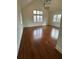 Bright bedroom with hardwood floors, vaulted ceiling, modern light fixture, and abundant natural light from large windows at 46 Montclair Ne Dr, Atlanta, GA 30309