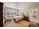 Serene bedroom with soft colors, plush carpet, a cozy armchair, and natural light streaming through shuttered windows at 46 Montclair Ne Dr, Atlanta, GA 30309