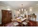 Elegant dining room featuring a classic wooden table, antique armoire, and ornate rug, perfect for Gathering gatherings at 46 Montclair Ne Dr, Atlanta, GA 30309