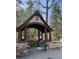 Charming entrance to Brookwood Hills with stone pillars, a wooden gazebo, and inviting bench at 46 Montclair Ne Dr, Atlanta, GA 30309