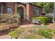 Charming home entrance featuring a brick walkway, bench seating, and lush greenery at 46 Montclair Ne Dr, Atlanta, GA 30309