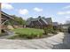Stately Tudor-style home with a manicured lawn, stone walkway, and a spacious driveway at 46 Montclair Ne Dr, Atlanta, GA 30309
