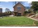 Beautiful brick home with manicured front yard, complemented by a charming entryway and mature landscaping at 46 Montclair Ne Dr, Atlanta, GA 30309