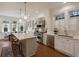 Stylish white kitchen with stainless steel appliances, a marble island with seating, and hardwood floors throughout at 46 Montclair Ne Dr, Atlanta, GA 30309