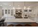 Expansive white kitchen featuring marble countertops, stainless steel appliances, and pendant lighting over a large center island at 46 Montclair Ne Dr, Atlanta, GA 30309