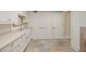 Well-organized laundry room featuring white cabinets, a farmhouse sink, and plenty of counter space at 46 Montclair Ne Dr, Atlanta, GA 30309