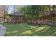 Relaxing outdoor seating area with Adirondack chairs, a stone wall, and a shady gazebo at 46 Montclair Ne Dr, Atlanta, GA 30309