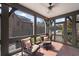 Charming screened-in porch with brick flooring, comfortable seating, and views of the lush surroundings, perfect for relaxing at 46 Montclair Ne Dr, Atlanta, GA 30309