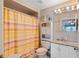 The bathroom features a shower with a curtain and vanity sink with a mirror and light at 5168 Parkview Rd, Social Circle, GA 30025