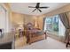 Comfortable bedroom featuring a wooden four-poster bed, neutral walls, and a view to the backyard at 5168 Parkview Rd, Social Circle, GA 30025