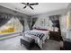 Bedroom with two large windows, grey walls, and a black and white checkered coverlet on the bed at 5168 Parkview Rd, Social Circle, GA 30025