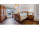 Well-lit bedroom with a bed, a window that looks out onto a beautiful view, and beautiful tile floors at 5168 Parkview Rd, Social Circle, GA 30025