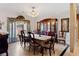 Formal dining room with a decorative chandelier, large china cabinet, and neutral decor at 5168 Parkview Rd, Social Circle, GA 30025