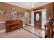 Entryway featuring tile flooring, a piano, chandelier, and a decorative front door at 5168 Parkview Rd, Social Circle, GA 30025