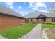 Charming brick home featuring a beautiful front yard, stone fountain, and a walkway leading to the front door at 5168 Parkview Rd, Social Circle, GA 30025