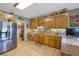 Well-equipped kitchen with stainless steel appliances, granite countertops, and custom wood cabinetry at 5168 Parkview Rd, Social Circle, GA 30025