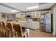 Updated kitchen showcases a large island, granite counters, stainless steel appliances, and plenty of cabinet space at 5168 Parkview Rd, Social Circle, GA 30025