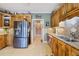 Updated kitchen featuring stainless steel refrigerator, granite countertops, custom cabinetry, and an eat-in area at 5168 Parkview Rd, Social Circle, GA 30025