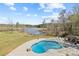 An aerial shot showcases a beautiful pool, lake, and lush green landscaping creating a stunning outdoor oasis at 5168 Parkview Rd, Social Circle, GA 30025