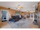 Expansive living room with tiled floors, ceiling fans, a leather sofa, and a large rug at 5168 Parkview Rd, Social Circle, GA 30025