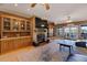 Open-concept living room with a fireplace, large built-ins, access to a deck, and lake views at 5168 Parkview Rd, Social Circle, GA 30025