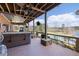 Expansive patio with a hot tub, a gorgeous view of the water, and outdoor seating under a wood ceiling at 5168 Parkview Rd, Social Circle, GA 30025